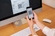 Person scans QR code of an invoice 